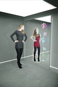 young girl shopping using augmented reality mirror with alternate fashion being shown